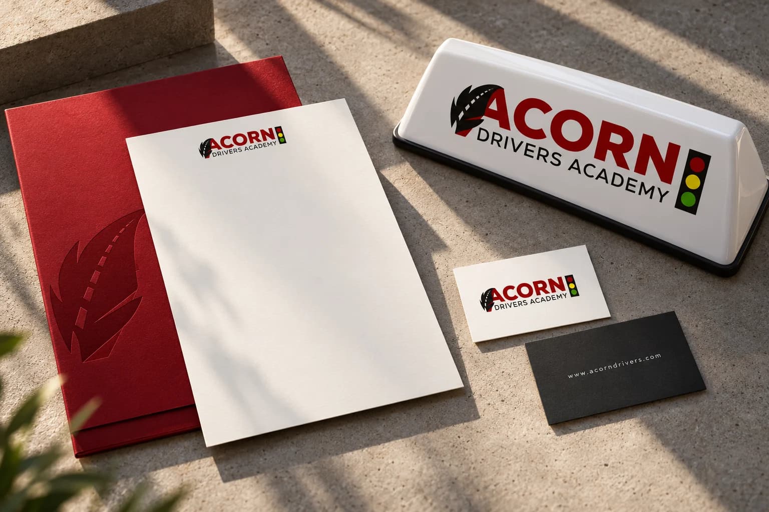 Acorn identity presented on stationery and a learner sign; contemporary concept mockup